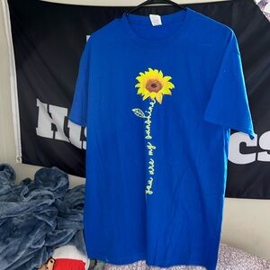 Women’s blue tee shirt with flower.